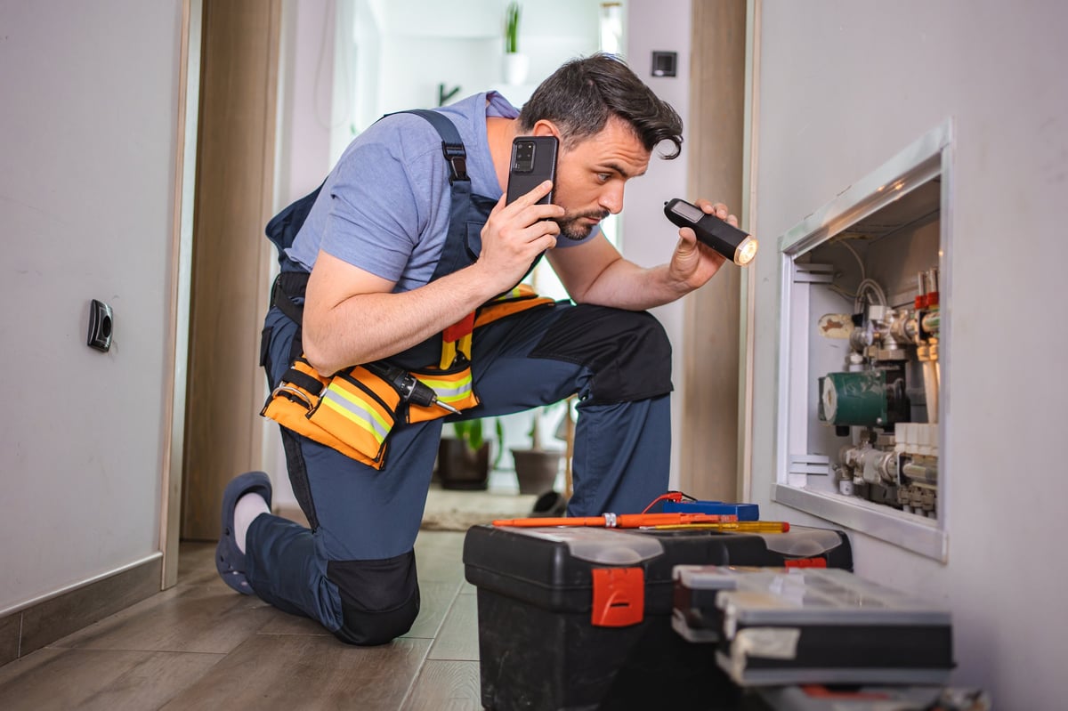 Technician inspecting heating system with professional diagnostic equipment